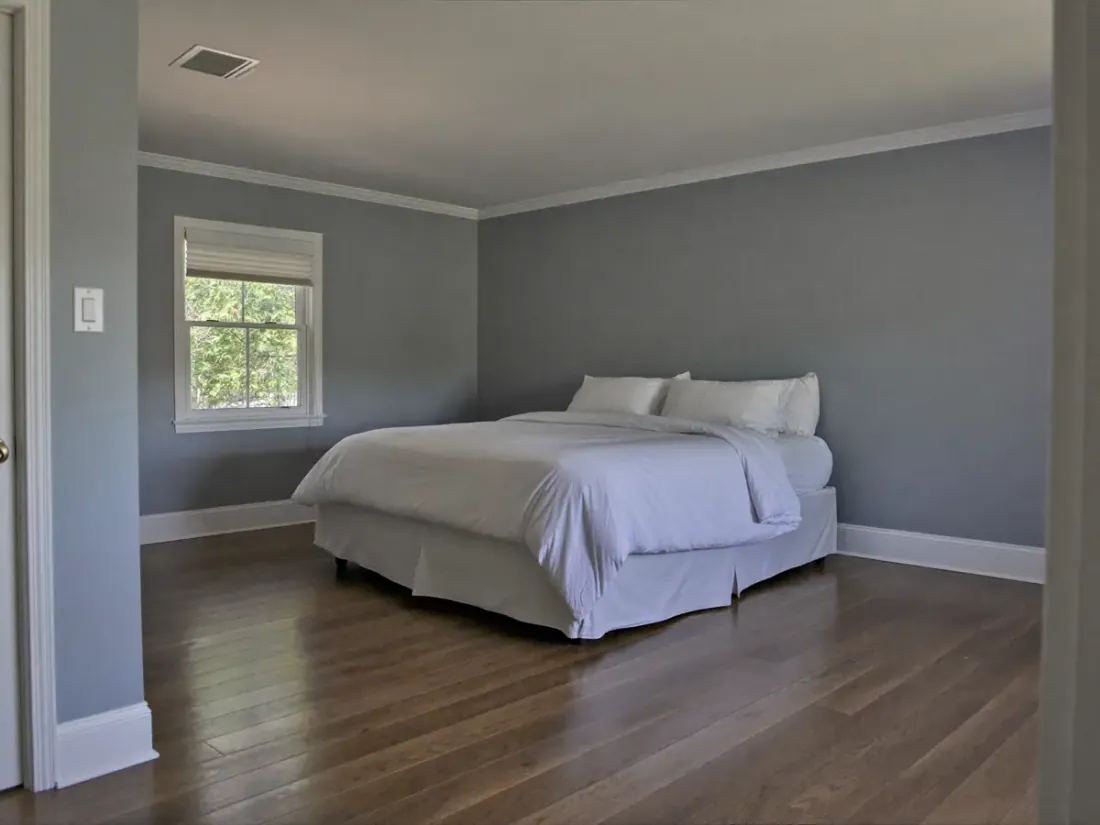 Freshly painted bedroom with a new hardwood floor in an East Texas home